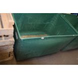 Plywood and green plastic laundry bin on casters