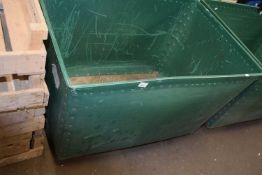 Plywood and green plastic laundry bin on casters