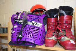 A pair of ski/snowboarding boots with body armour and helmet