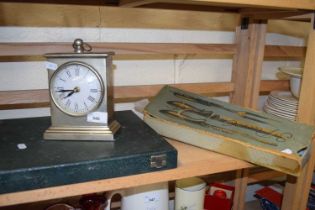 White metal mantel clock together with an antler handled carving set and another carving set