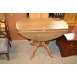 A modern oak veneered drop leaf kitchen table