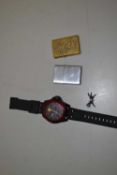 Modern Ferrari wristwatch and two vintage Zippo cigarette lighters