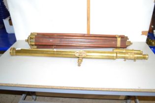 A reproduction brass telescope and accompanying hardwood tripod
