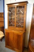 A lead glazed bookcase cabinet with cupboard base