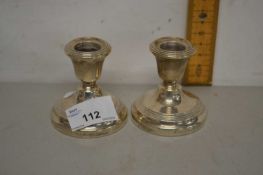 Pair of small silver mounted dressing table candlesticks with loaded bases