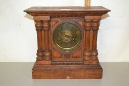 Late 19th Century mantel clock set in an architectural wooden case with pillared decoration