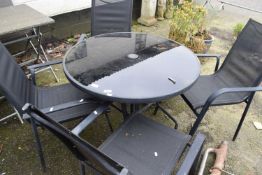 A black metal framed garden table and four chairs