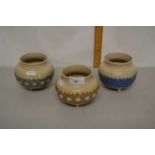 Group of three Royal Doulton cauldron style vases with floral decorations