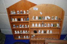 Two wall display cabinets of various thimbles