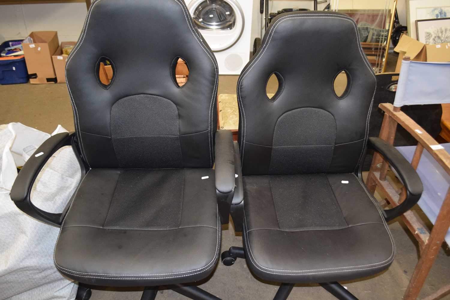 Two black swivel office chairs