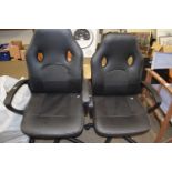 Two black swivel office chairs