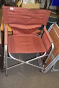 An aluminium framed canvas folding chair with side table