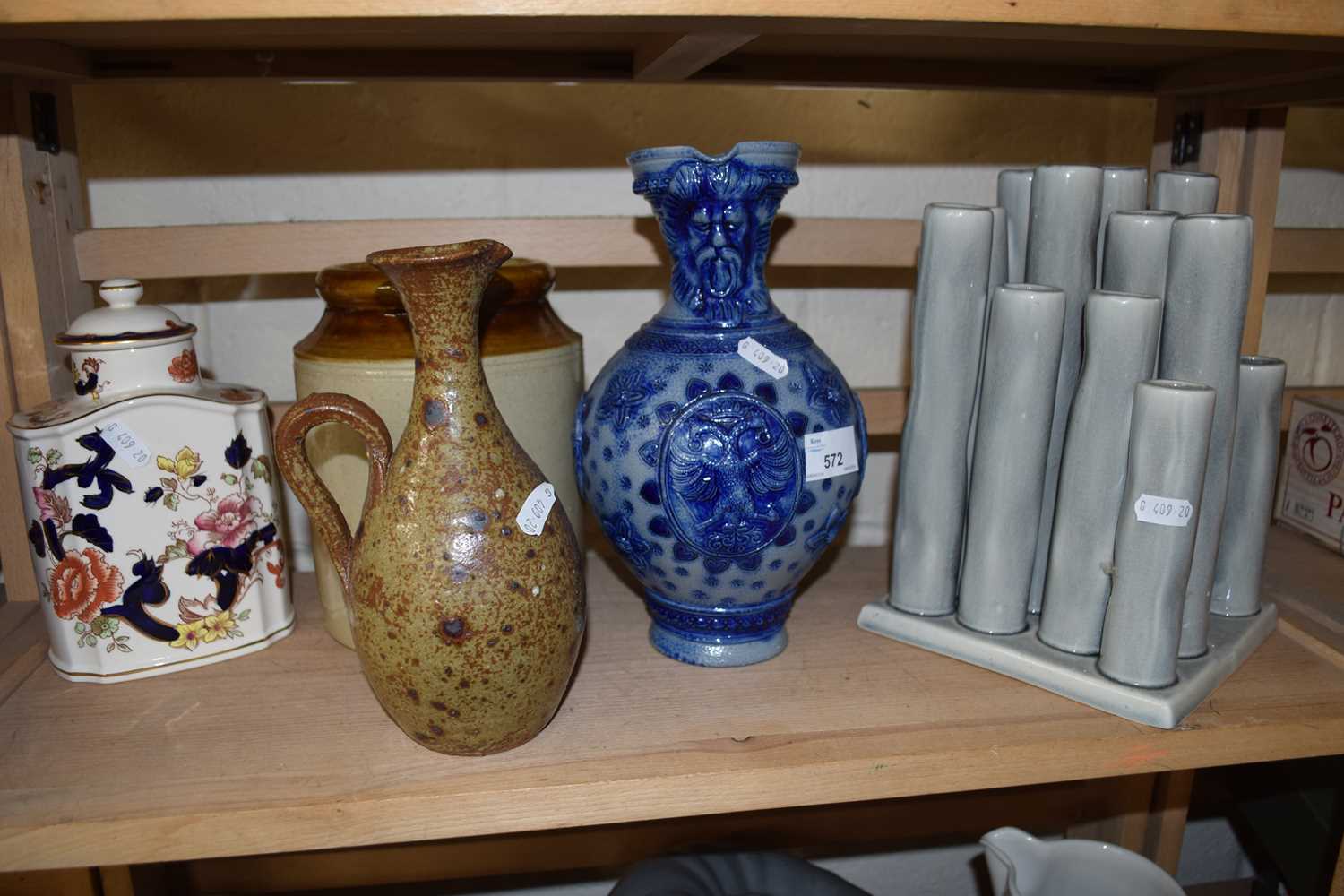 A German salt glazed jug together with tea caddy and others and a contemporary green tubular vase