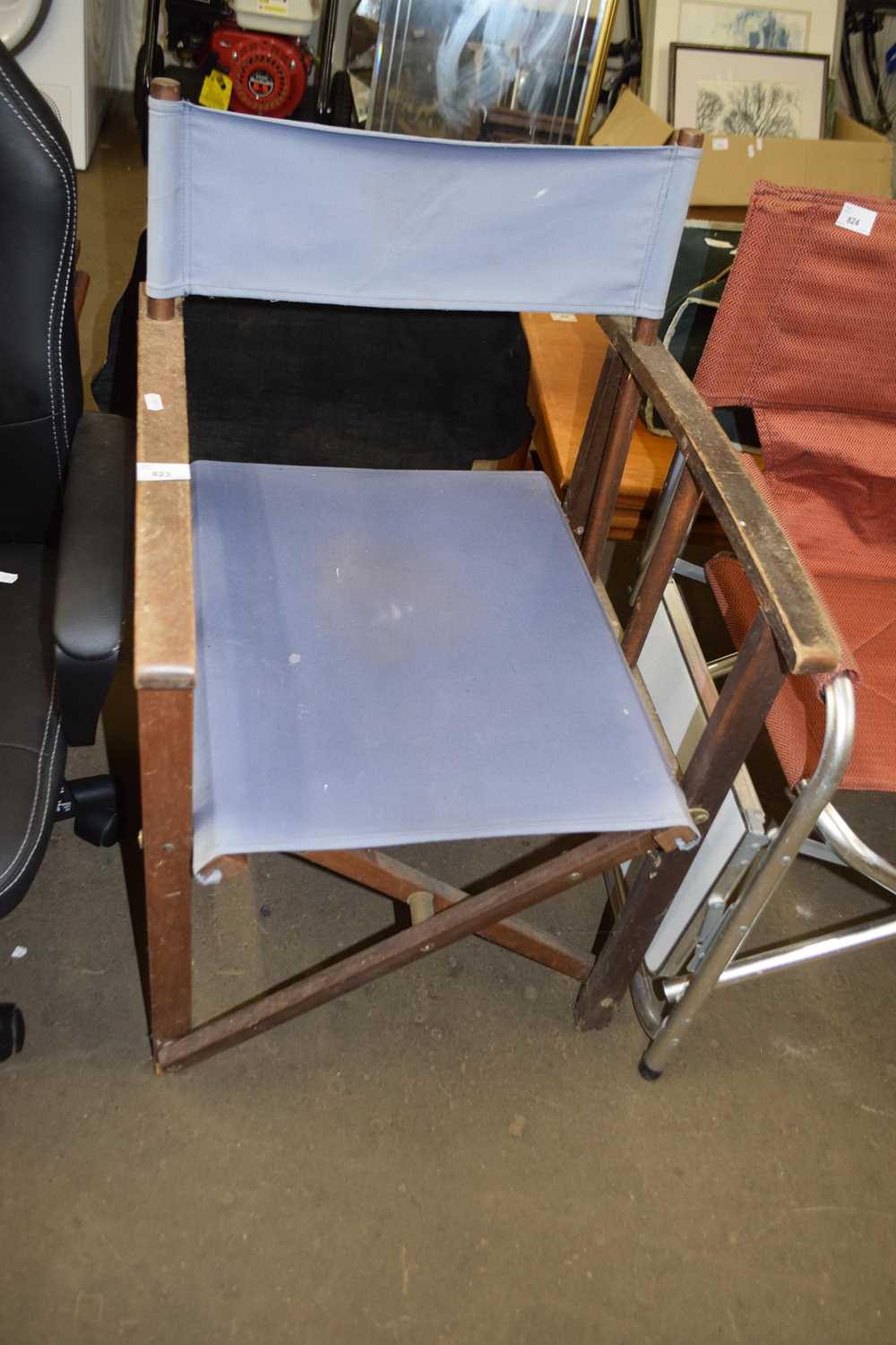 A canvas seated folding chair