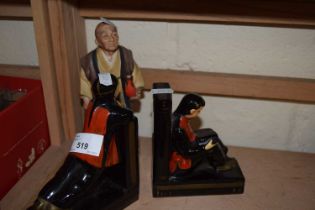 A pair of Chinese style book ends and a figurine