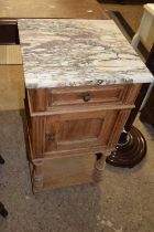 A late 19th Century continental bedside cabinet with grey veined marble top