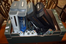 Box of four x Xbox 360 games consoles with controls