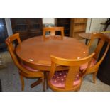 Modern circular pedestal dining table and four accompanying chairs