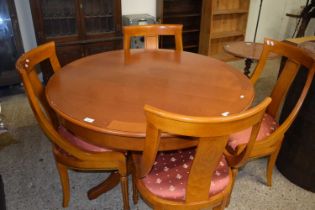 Modern circular pedestal dining table and four accompanying chairs