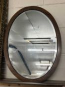 Early 20th Century oak framed oval bevelled wall mirror