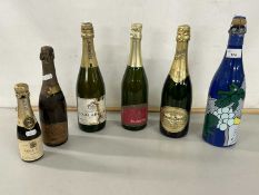 A group of six various bottles of champagne and sparkling wine