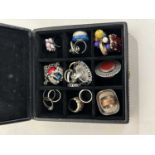 Small case with various costume jewellery rings