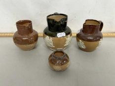 Group of four small Doulton jugs and a similar condiment pot