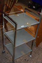 A chrome and frosted glass bathroom shelf