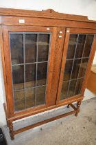 An early 20th Century oak lead glazed bookcase cabinet on barley twist legs