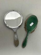 An enamel backed dressing table brush and mirror