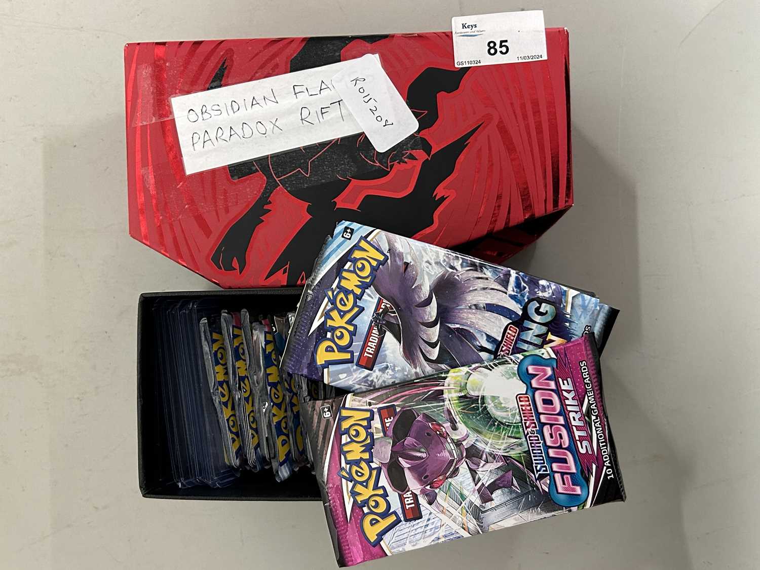 Box of Pokemon cards to include Obsidian Flames