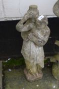 Weathered concrete garden statue of a water carrier, 70cm high