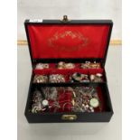 A case of various assorted costume jewellery