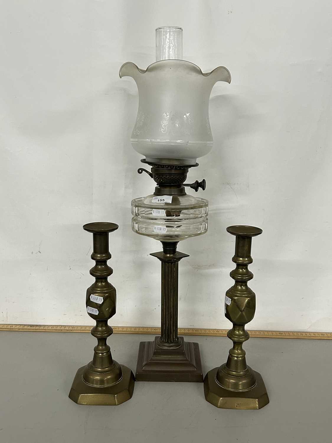 Brass based oil lamp and a pair of brass candlesticks