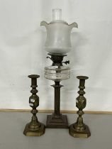 Brass based oil lamp and a pair of brass candlesticks