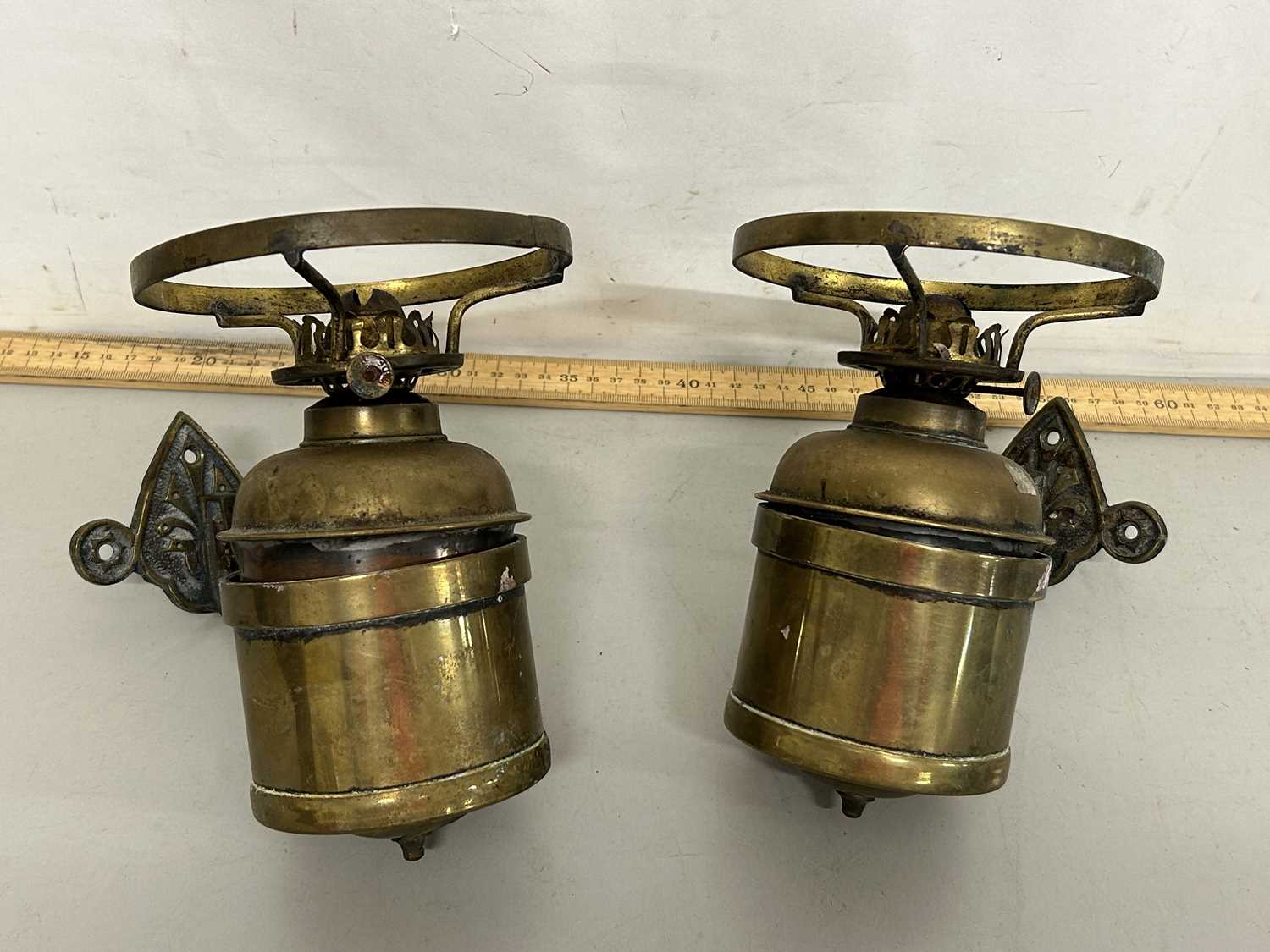 Two brass wall mounted oil lamps
