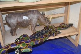 Model rhino and a painted wooden salamander