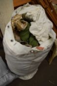 A large bag of various army surplus clothing and others