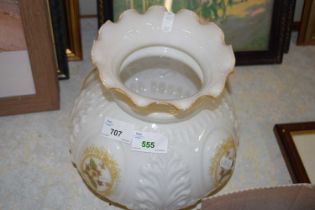 An oil lamp shade with floral decoration