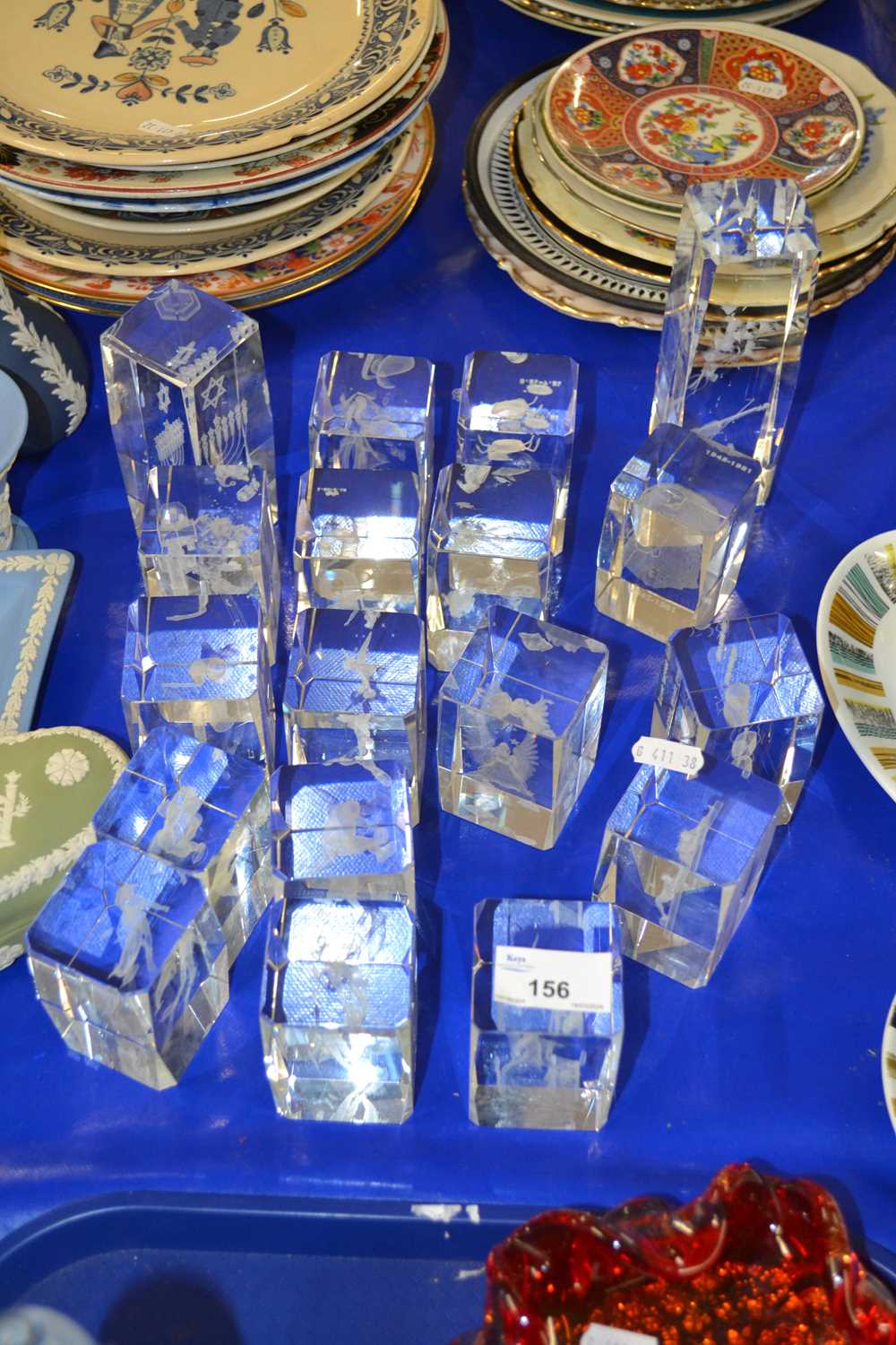 Group of modern clear glass paperweights decorated with various figures