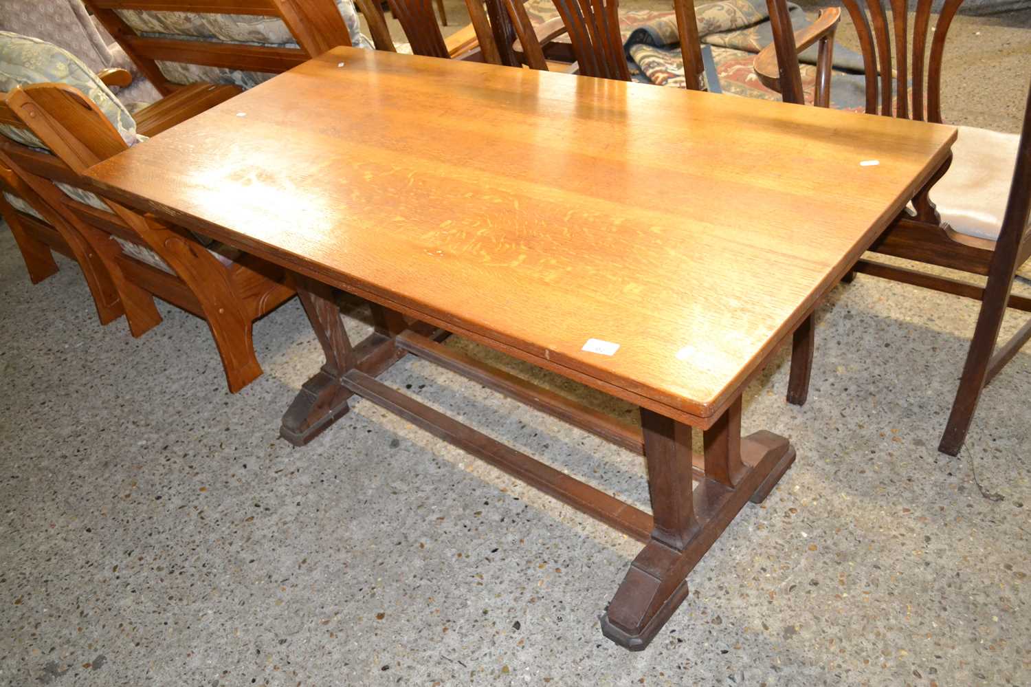 An Arts & Crafts style oak refectory dining table, the ends with twin supports, supporting a twin