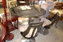 A retro pedestal chrome based dining table with smoked glass top together with a set of four