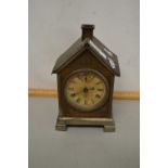 A small early 20th Century mantel clock set in a novelty metal case formed as a chalet