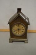 A small early 20th Century mantel clock set in a novelty metal case formed as a chalet