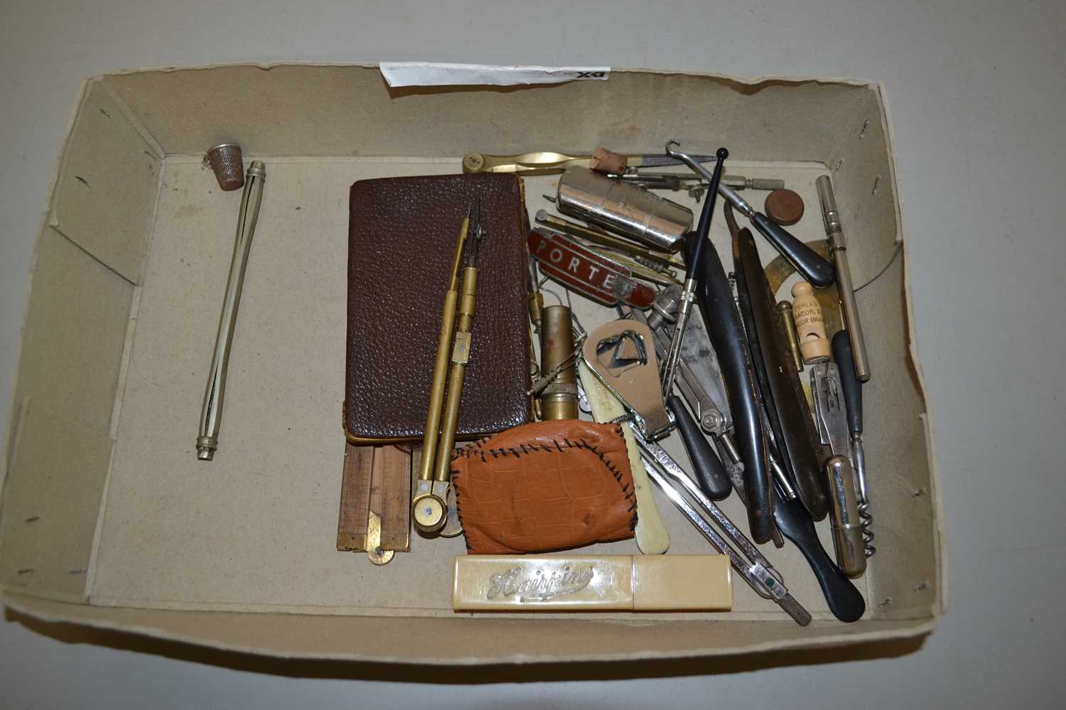 A box of various assorted technical drawing instruments and other items