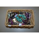 A basket of various assorted costume jewellery