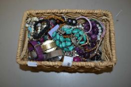 A basket of various assorted costume jewellery