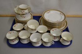 A quantity of rose and gilt rimmed tea wares
