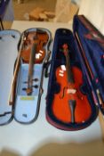 Two modern cased violins