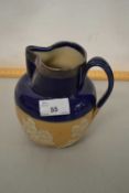 A Doulton stone ware harvest jug with silver collar